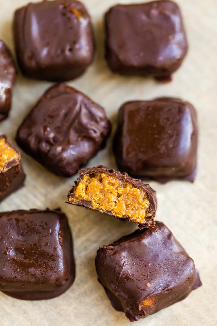 Overhead shot of chocolate covered butterfinger bites on a pan.