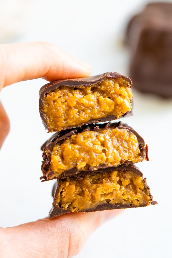 Hand holding a stack of homemade butterfinger bites.