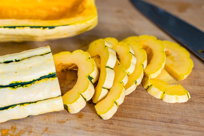 Delicata squash being cut.