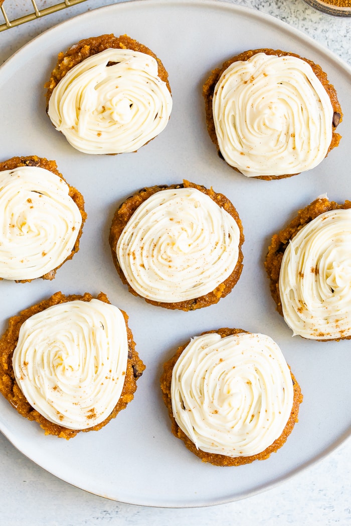 Plate with iced pumpkin cookies.