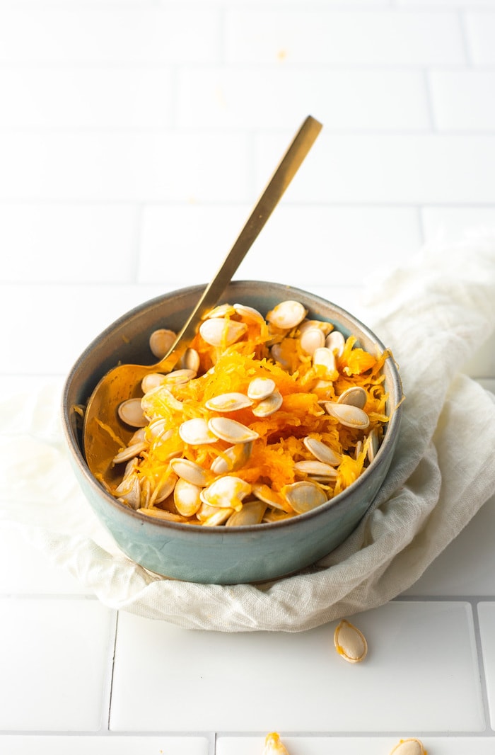 Pumpkin guts in a bowl.