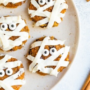 Plate with cute pumpkin mummy decorated cookies.