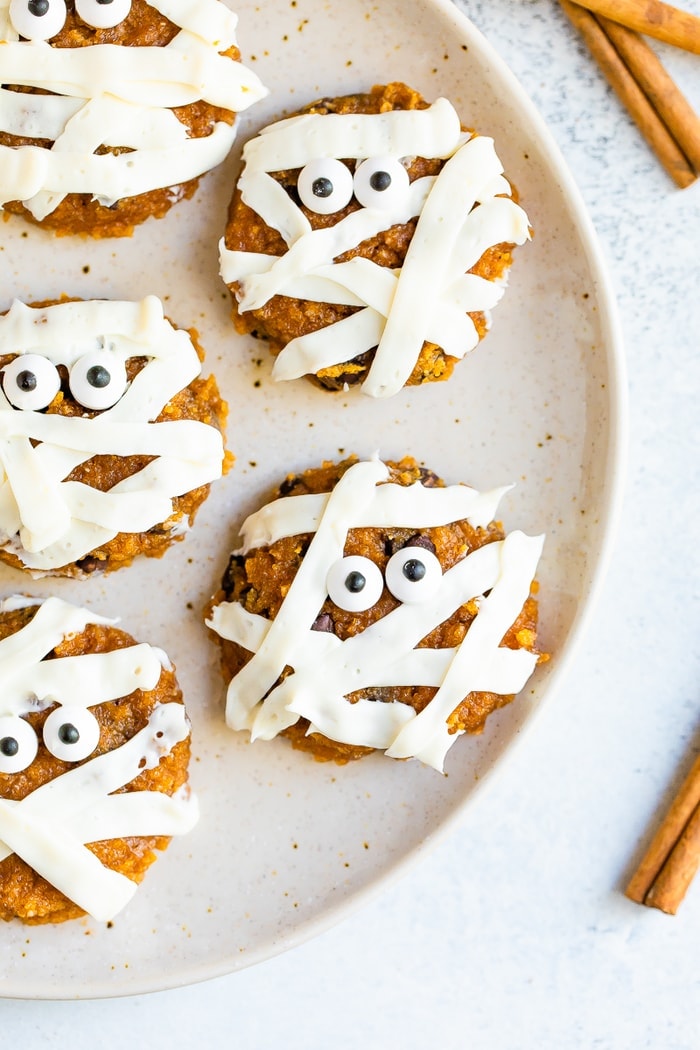 Plate with cute pumpkin mummy decorated cookies.