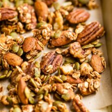 Spiced seeds, nuts and oats on a baking sheet.