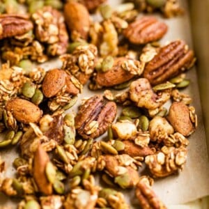 Spiced seeds, nuts and oats on a baking sheet.