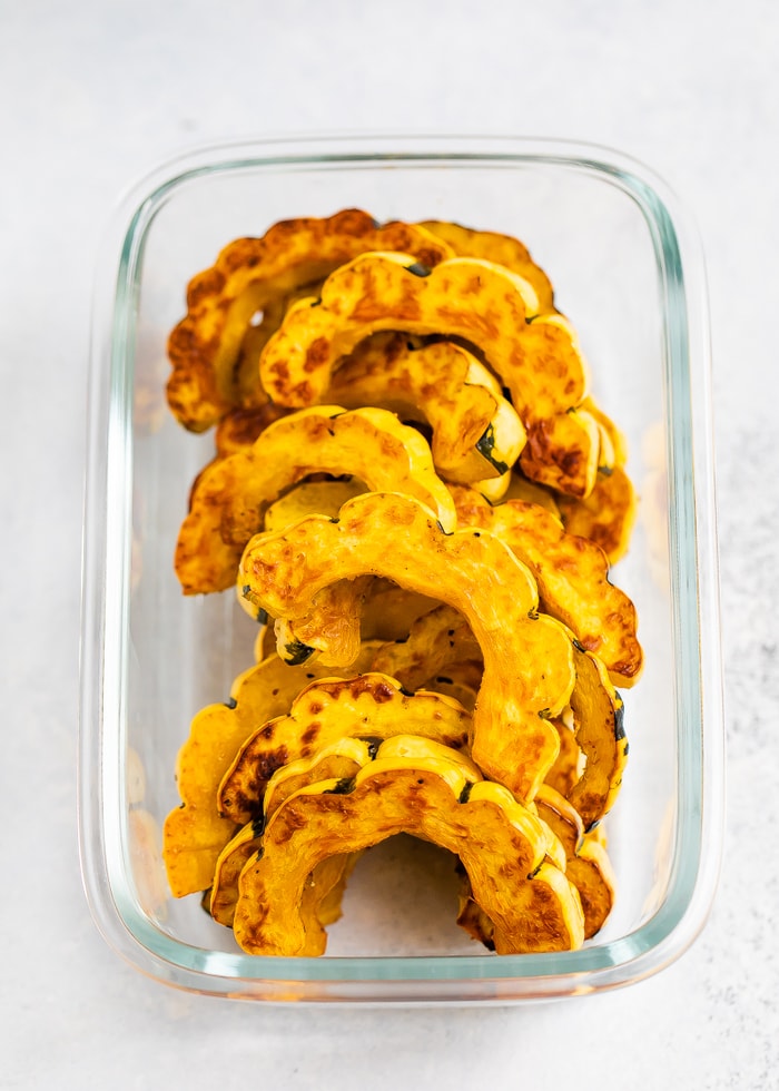 Roasted delicata squash in a food storage container.