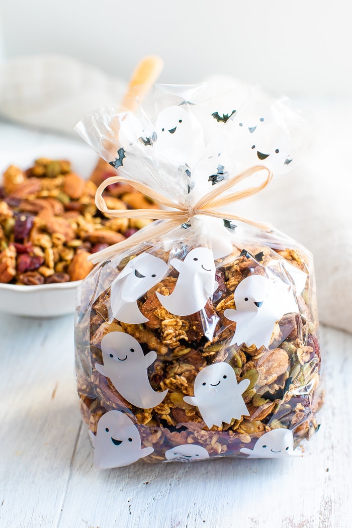 Cute ghost treat bag filled with pumpkin spice trail mix and tied with a bow.