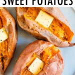 Three baked sweet potatoes on a plate topped with butter, salt and pepper.