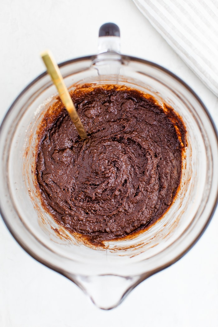 Glass mixing bowl with brownie batter.
