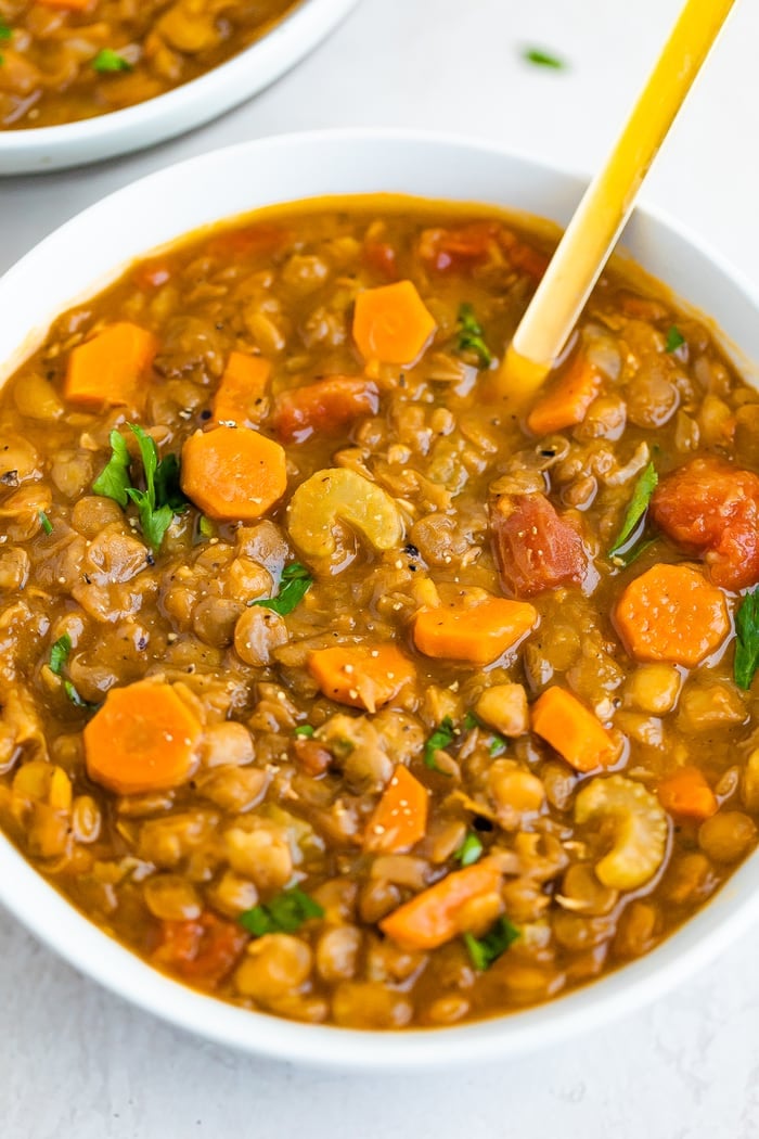 Bowl of lentil soup with celery and carrots.