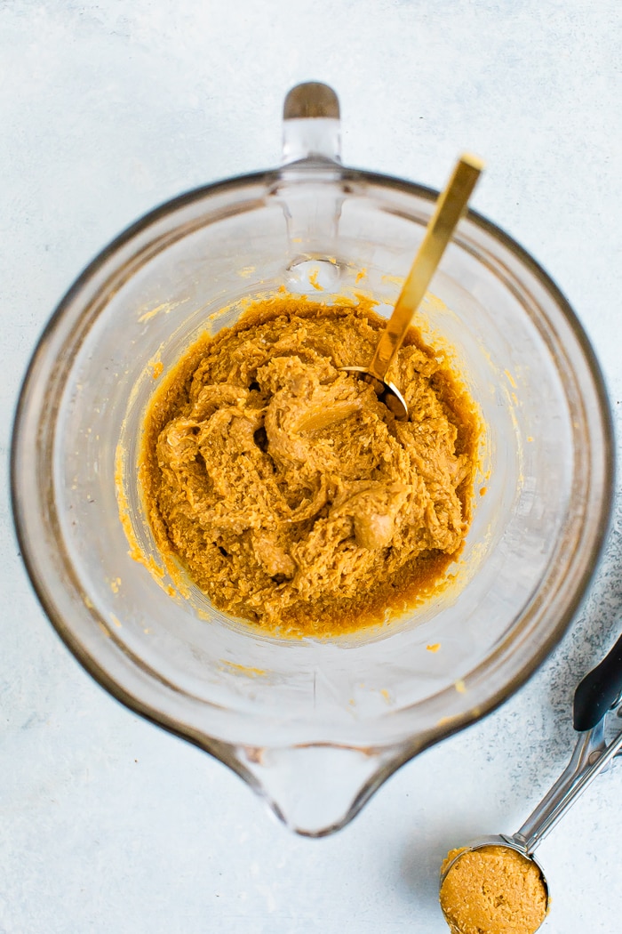 Glass mixing bowl with peanut butter cookie batter.