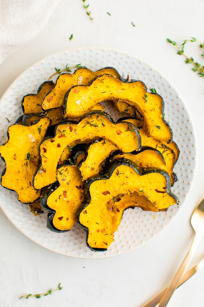 Slice of roasted acorn squash with spices on it.