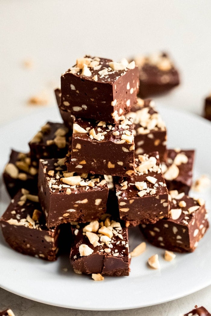 Tower stack of fudge cubes studded with chopped peanuts.