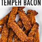 Crispy tempeh bacon on a plate.