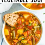 Bowl of vegetable soup with a slice of crusty bread.