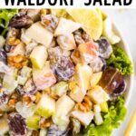 Waldorf salad served in a bowl over lettuce.