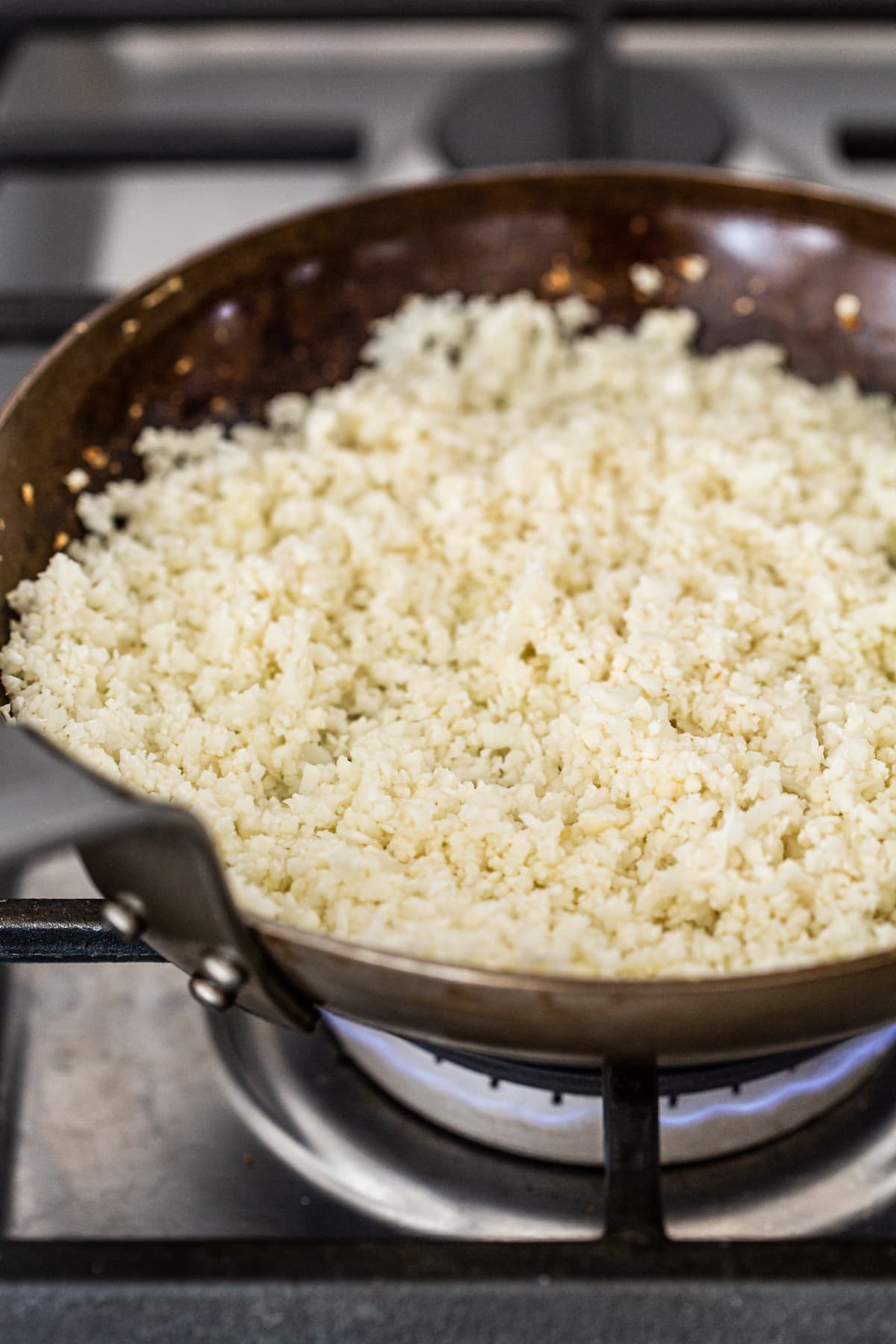 Cauliflower cooking in a pan.