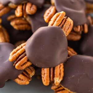 Close up photo of homemade turtle candies made with pecans, date caramel and chocolate.