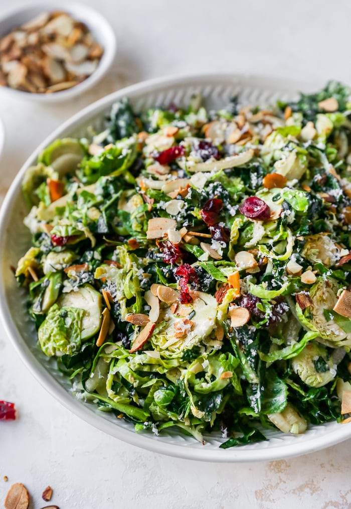 Kale and brussels sprout salad in a serving bowl.