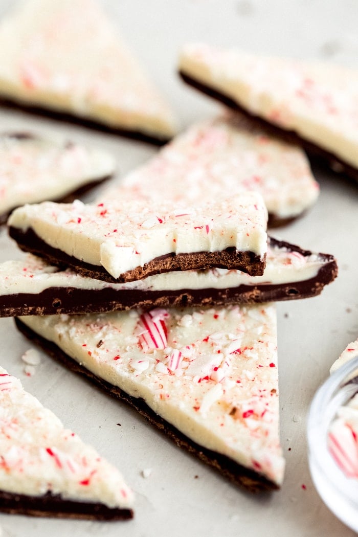 Triangles of peppermint bark. One has a bite taken out of it.