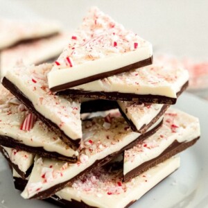 Stacked triangles of peppermint bark on a plate.