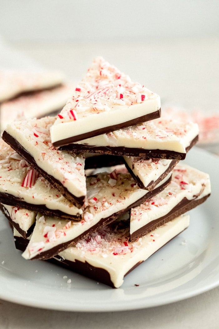 Stacked triangles of peppermint bark on a plate.