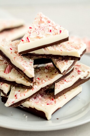 Stacked triangles of peppermint bark on a plate.