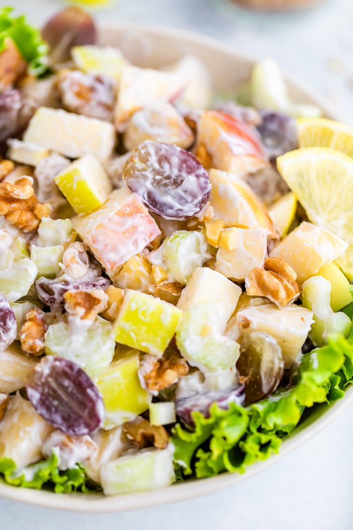 Waldorf salad served in a bowl over lettuce.