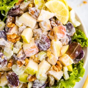 Waldorf salad served in a bowl over lettuce.