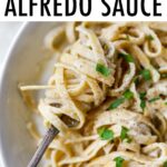 Fork twirling a bite of linguine alfredo.