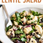 Plate with roasted cauliflower lentil salad and a fork.