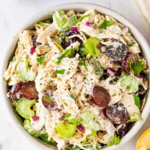 Bowl of chicken salad with grapes and celery.