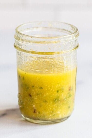 Mason jar with horseradish salad dressing.