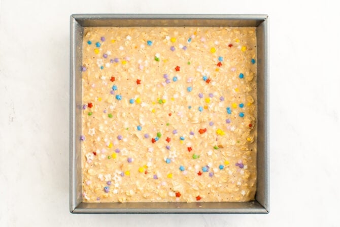 Square pan with batter for birthday cake oatmeal.