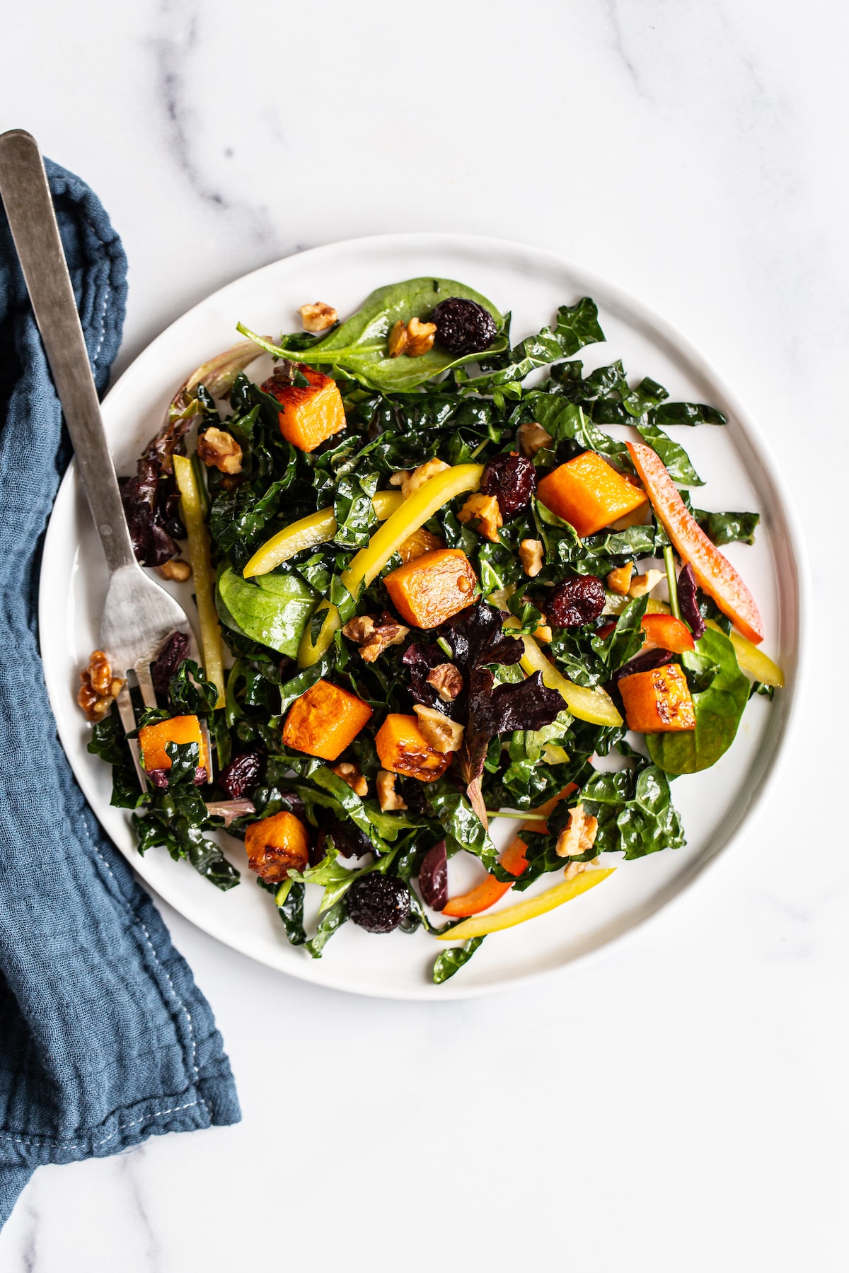 Plate with butternut squash and kale salad.