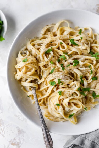 Fork twirling a bite of linguine alfredo.