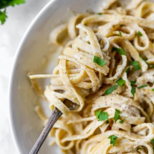 Fork twirling a bite of linguine alfredo.