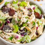 Bowl of chicken salad made with celery and grapes.