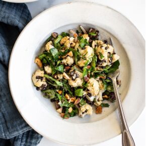 Plate with roasted cauliflower lentil salad and a fork.