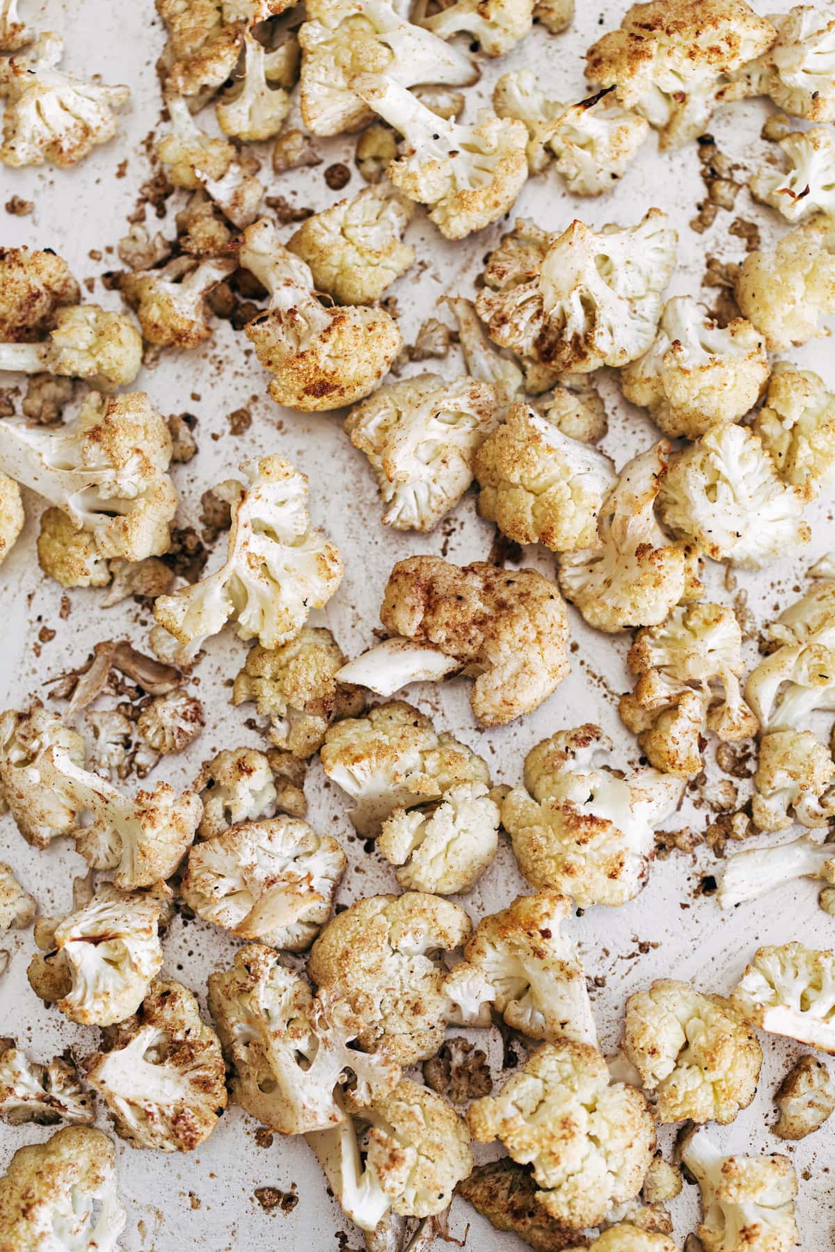 Roasted cauliflower on a sheet pan.