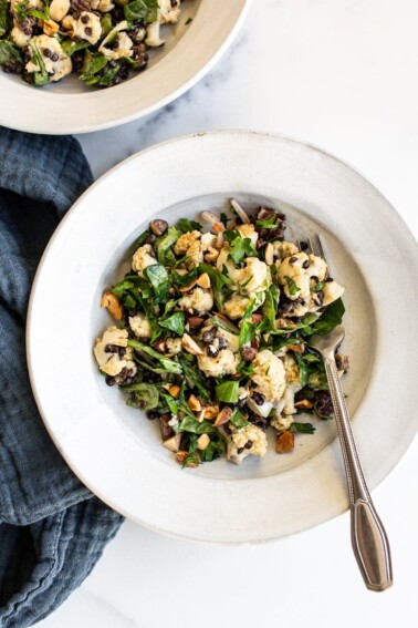 Plate with roasted cauliflower lentil salad and a fork.