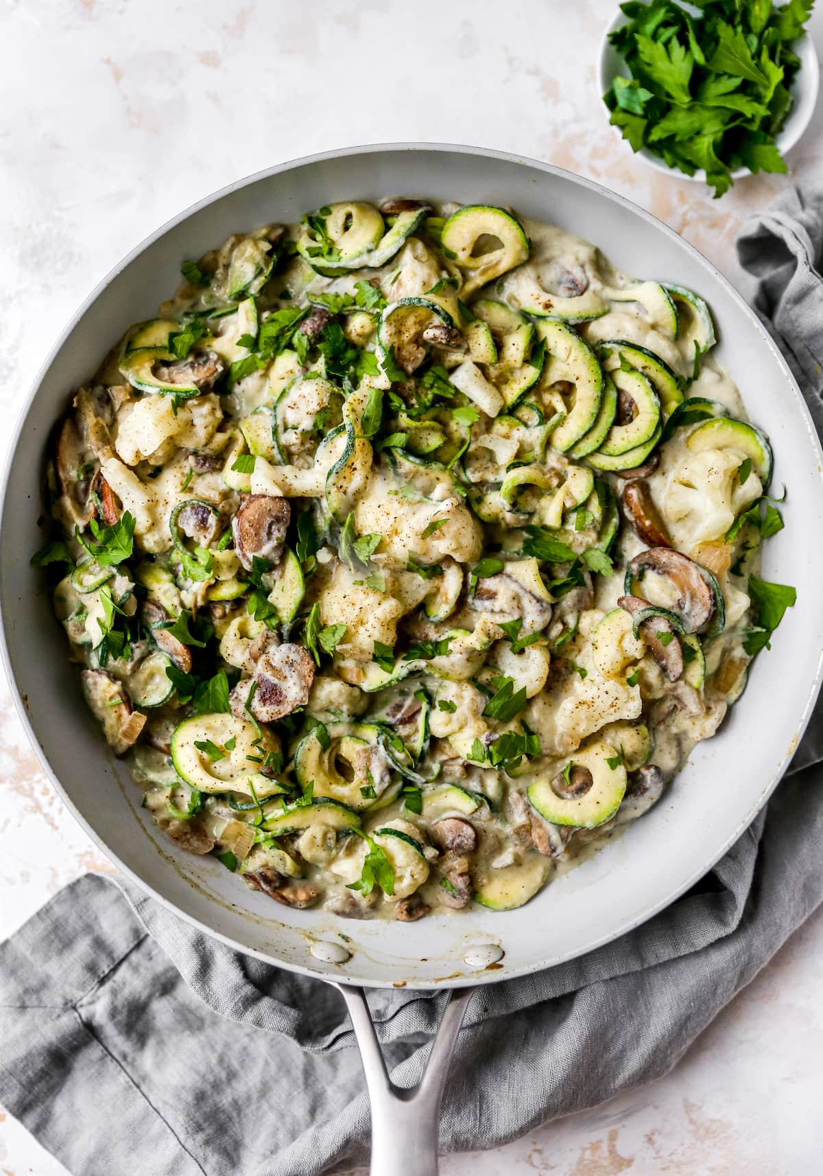 Zucchini noodle alfredo in a skillet.