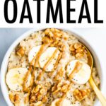 Bowl of oatmeal topped with bananas, walnuts and peanut butter.