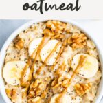 Bowl of oatmeal topped with bananas, walnuts and peanut butter.