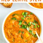 Bowl of butternut squash lentil stew topped with parsley.