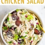 Bowl of chicken salad with grapes and celery.