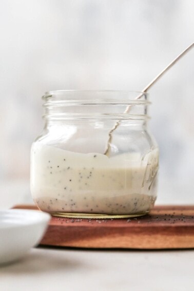 Jar and spoon with poppyseed dressing