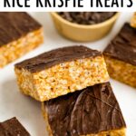 Two rice krispie treats topped with chocolate balanced on top of each other.