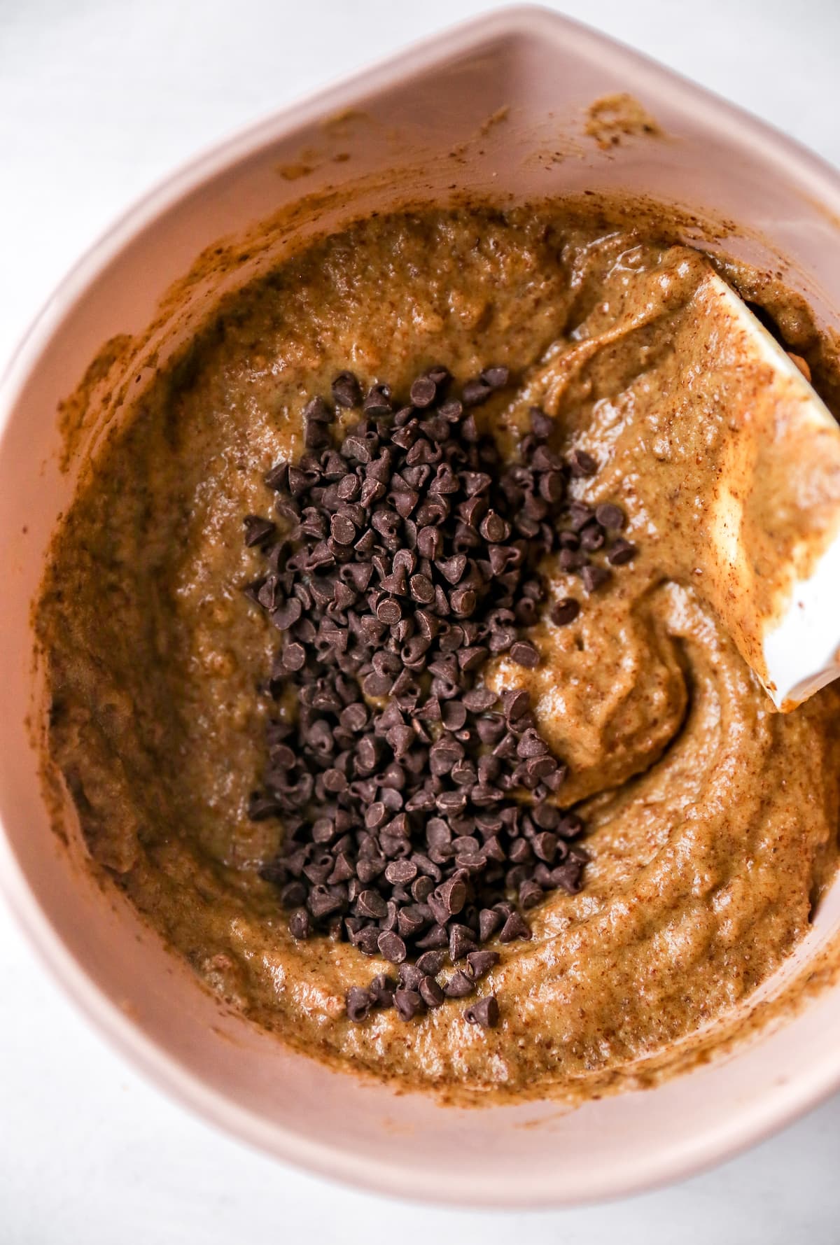 Mixing bowl with muffin batter and chocolate chips.