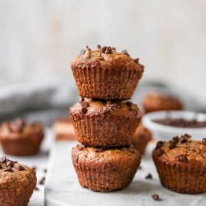 Stack of three chocolate chip almond flour muffins.